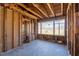 Interior view of a room during renovation, showing studs, and a bright window overlooking the yard at 382 Golfview Nw Rd, Atlanta, GA 30309