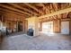 Living room in renovation showing fireplace, exposed beams, and a view of a window at 382 Golfview Nw Rd, Atlanta, GA 30309
