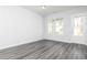 Well-lit bedroom with neutral walls, modern flooring, and a doorway to the backyard at 103 Cedar Brook Dr, Holly Springs, GA 30115