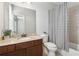 Bathroom with dark wood cabinet, granite top vanity and a shower and tub combination at 2959 Rivergreen Se Ln, Atlanta, GA 30339