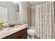 Well-lit bathroom with vanity, granite countertop, and tiled shower at 2959 Rivergreen Se Ln, Atlanta, GA 30339