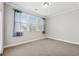 Neutral bedroom featuring large window, light carpet and baseboards at 2959 Rivergreen Se Ln, Atlanta, GA 30339