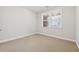 Bedroom features neutral walls, carpet, base trim, and a window at 2959 Rivergreen Se Ln, Atlanta, GA 30339