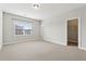 Neutral bedroom featuring large window, light carpet, baseboards and closet at 2959 Rivergreen Se Ln, Atlanta, GA 30339