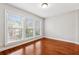 Bedroom featuring hardwood floors, three windows, and neutral wall color at 2959 Rivergreen Se Ln, Atlanta, GA 30339