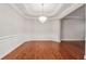 Formal dining room featuring hardwood floors, wainscoting, trey ceilings, and elegant chandelier at 2959 Rivergreen Se Ln, Atlanta, GA 30339