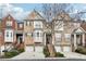 Attractive brick townhome featuring multiple units, covered entrances, and attached garages at 2959 Rivergreen Se Ln, Atlanta, GA 30339