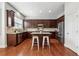 Well-lit kitchen with dark cabinets, stainless steel appliances, and center island with bar stools at 2959 Rivergreen Se Ln, Atlanta, GA 30339