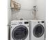 Bright laundry room features modern, front-loading washer and dryer, plus wire shelving for storage at 2959 Rivergreen Se Ln, Atlanta, GA 30339