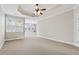 This main bedroom boasts a tray ceiling with fan, and great natural light from many windows at 2959 Rivergreen Se Ln, Atlanta, GA 30339