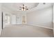 Spacious main bedroom featuring neutral colors, tray ceiling with a fan, and multiple entryways at 2959 Rivergreen Se Ln, Atlanta, GA 30339