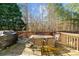 Wooden deck featuring an outdoor dining table and chairs, surrounded by a lush green forest at 404 Glenleigh Dr, Canton, GA 30114