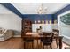 A formal dining room featuring wood floors, crown molding, and a large window at 404 Glenleigh Dr, Canton, GA 30114