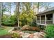 Backyard featuring a stone staircase, a screened porch, mature trees and landscaping at 5525 Whitner Dr, Sandy Springs, GA 30327
