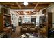Finished basement with a cozy seating area, exposed ceiling beams, and wood-look flooring at 5525 Whitner Dr, Sandy Springs, GA 30327
