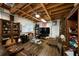 Finished basement with a cozy seating area, exposed ceiling beams, and wood-look flooring at 5525 Whitner Dr, Sandy Springs, GA 30327