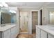 Modern bathroom featuring double vanity, tile floors, and a glass-enclosed shower at 5525 Whitner Dr, Sandy Springs, GA 30327