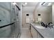 Modern bathroom with a walk-in shower, granite countertop vanity, and a large mirror at 5525 Whitner Dr, Sandy Springs, GA 30327