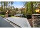 A long driveway leads up to the house, framed by stone pillars and manicured greenery at 5525 Whitner Dr, Sandy Springs, GA 30327
