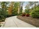 Long driveway lined with a retaining wall and lush plants at 5525 Whitner Dr, Sandy Springs, GA 30327