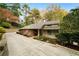 Charming home featuring a brick facade, neutral siding, and a well-manicured lawn at 5525 Whitner Dr, Sandy Springs, GA 30327