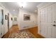 Cozy hallway with hardwood floors, leading into the house. Notice the elegant rugs and decorations at 5525 Whitner Dr, Sandy Springs, GA 30327