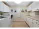 Functional laundry room with washer, dryer, ample counter space, and storage cabinets at 5525 Whitner Dr, Sandy Springs, GA 30327