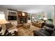 Inviting living room featuring a stone fireplace, built-in shelving, and plush seating with lots of natural light at 5525 Whitner Dr, Sandy Springs, GA 30327