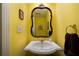 Stylish powder room featuring yellow walls and ornate mirror at 5525 Whitner Dr, Sandy Springs, GA 30327