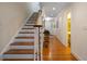 Inviting foyer with a staircase leading to the upper level and hardwood floors at 5525 Whitner Dr, Sandy Springs, GA 30327