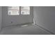 Unfinished bedroom with bare white walls, concrete floors, and natural light from two large windows at 2017 Ripple Park Bnd, Canton, GA 30114