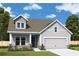 Charming new construction home with a two-car garage, dormer window, and landscaped front yard at 2017 Ripple Park Bnd, Canton, GA 30114