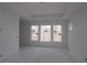 Spacious unfinished main bedroom with tray ceiling and large windows providing ample natural light at 2017 Ripple Park Bnd, Canton, GA 30114