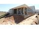 Rear exterior view of home with covered porch and large windows overlooking the backyard at 2017 Ripple Park Bnd, Canton, GA 30114