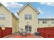 A backyard with a red fence and a table and chairs on a red patio at 2403 Brianna Dr, Hampton, GA 30228