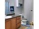 Classic bathroom with a tiled floor, wood cabinet, white toilet, and vanity for essential bathroom supplies at 2403 Brianna Dr, Hampton, GA 30228