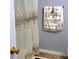 Elegant bathroom featuring embroidered lace shower curtain and matching towels, adding a touch of sophistication at 2403 Brianna Dr, Hampton, GA 30228