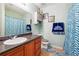 Well-maintained bathroom with a sink, cabinet, and shower with blue patterned curtains, creating a coordinated look at 2403 Brianna Dr, Hampton, GA 30228