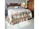 Bedroom featuring a comfortable bed with decorative bedding and classic wooden furniture for storage at 2403 Brianna Dr, Hampton, GA 30228