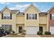Inviting townhouse featuring a one-car garage, complemented by a well-maintained lawn and charming exterior at 2403 Brianna Dr, Hampton, GA 30228