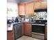 Well-equipped kitchen with wooden cabinets, stainless steel appliances, and a stylish backsplash at 2403 Brianna Dr, Hampton, GA 30228