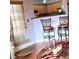 Bright breakfast nook with barstool seating, hardwood floors, and a view of the kitchen at 2403 Brianna Dr, Hampton, GA 30228