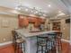 Kitchen wet bar featuring granite countertops, wooden cabinets, and barstool seating at 1258 Mcallistar Dr, Locust Grove, GA 30248