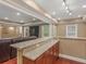 Kitchen wet bar featuring granite countertops and wooden cabinets with a view of the adjacent living room at 1258 Mcallistar Dr, Locust Grove, GA 30248