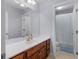 Bright bathroom with a wooden vanity, a large mirror, and a separate toilet and shower area at 1258 Mcallistar Dr, Locust Grove, GA 30248