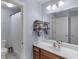 Bright bathroom with a sink, large mirror, and a shower with a white curtain at 1258 Mcallistar Dr, Locust Grove, GA 30248