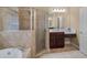 Bathroom featuring a tiled shower, soaking tub, and vanity with sink and storage space at 1258 Mcallistar Dr, Locust Grove, GA 30248