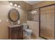 Bathroom with tiled walk-in shower, tile floors, vanity with framed mirror and updated toilet at 1258 Mcallistar Dr, Locust Grove, GA 30248