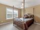 Bedroom with a gold metal canopy bed, a ceiling fan, and a window with blinds at 1258 Mcallistar Dr, Locust Grove, GA 30248