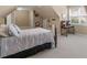 Neutral carpeted bedroom with large bed and a sports poster on the wall at 1258 Mcallistar Dr, Locust Grove, GA 30248